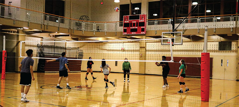 Students playing volleyball in the Rec Center.